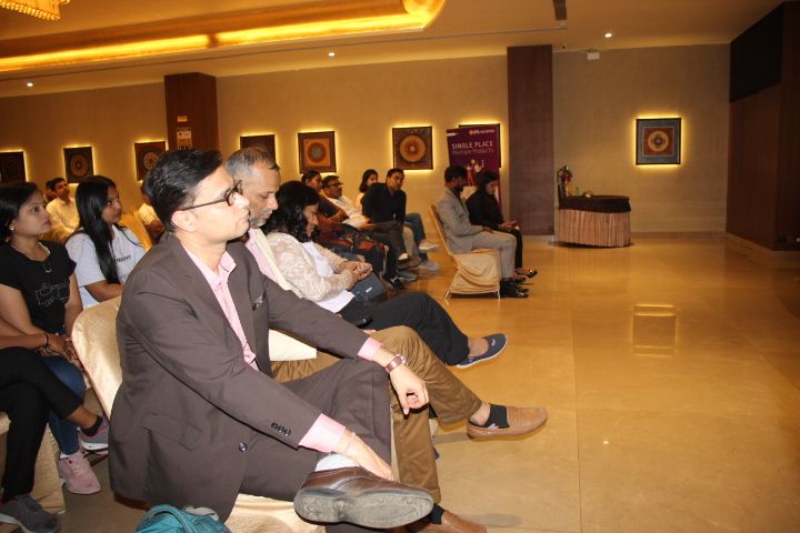 Attendees seated and listening in the hall