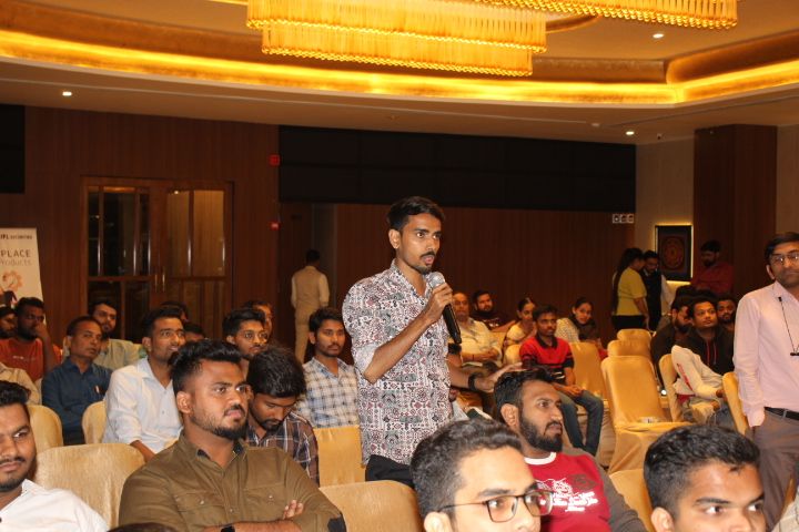 An attendee asking a question with a microphone during the session